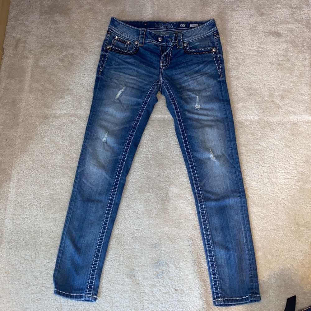 Miss Me cuffed skinny jeans with brown and white stitching patterns.